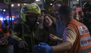 A woman reacts at the scene of a shooting attack In Tel Aviv, Israel, Thursday, April 7, 2022. Israeli police say several people were wounded. (AP)