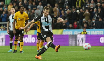 Newcastle United's Chris Wood scores their first goal from the penalty spot Action. (Reuters)