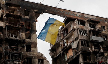 A torn flag of Ukraine hung on a wire in front an apartment building destroyed during Ukraine-Russia conflict in the southern port city of Mariupol. (Reuters)