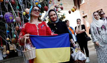 Ukrainian faithful display the Ukrainian flag as they attend the Easter service at the courtyard of the ecumenical patriarchate in Istanbul on Sunday. (Reuters)