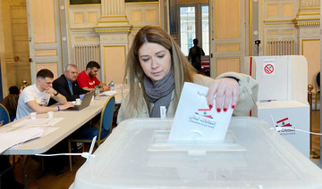 A Lebanese expat casts her vote for Lebanon's parliamentary election in Paris, France, May 8, 2022. (REUTERS)