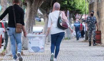 Lebanese civil servants receive sealed ballot boxes at the governmental saray in Sidon on May 14, 2022. (AFP)