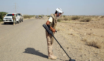 A member of Yemen's pro-government forces searches for land mines near al-Jawba frontline in the village of Hays, Hodeida. (AFP)