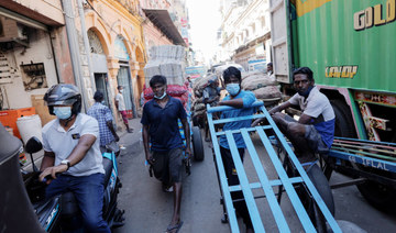 Men wait with their carts at a market, amid the country's economic crisis in Colombo, Sri Lanka. (REUTERS)