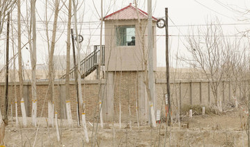 A security person watches from a guard tower around a detention facility in China's Xinjiang Uyghur Autonomous Region. (AP)