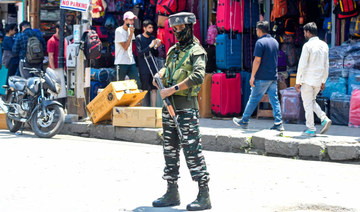 An Indian paramilitary trooper stands guard along a street during a random search in Srinagar on June 3, 2022. (AFP)
