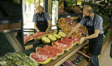 A worker arranges fruit for sale a food market in Ankara, Turkey, Friday, June 3, 2022. (AP)