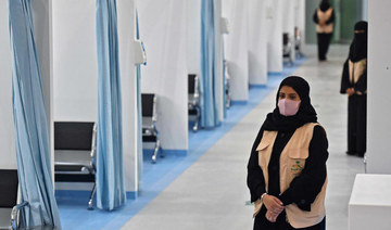 Nursing staff wait at the location where the Pfizer-BioNTech COVID-19 coronavirus vaccine is being administered in Riyadh. (AFP)
