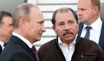 Nicaragua's President Daniel Ortega, right, and Russian President Vladimir Putin, left, attend a welcome ceremony at an airport 
