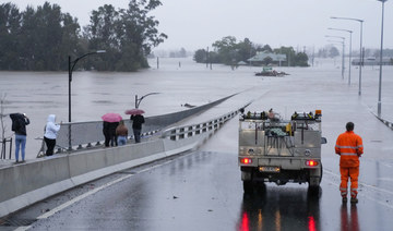 An emergency vehicle blocks access to the flooded Windsor Bridge on the outskirts of Sydney, Australia, Monday, July 4, 2022. 