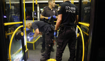 Israeli security inspect a bus after an attack outside Jerusalem's Old City, August 14, 2022. (AFP)