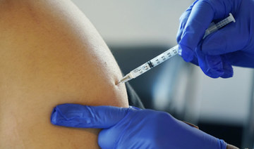 A resident receives a Pfizer booster shot from a nurse at a vaccination center. (AP)