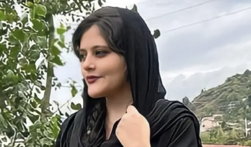 Iran police fire tear gas as protests erupt at funeral of woman arrested by morality police