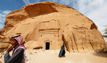 Visitors tour at majestic rock-hewn tombs of Madain Saleh near the city al-Ula, Saudi Arabia. (REUTERS)
