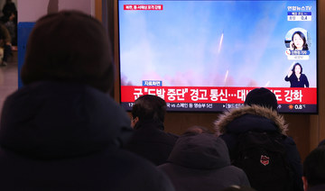 People watch a report on North Korea's artillery firings, at Seoul Station in Seoul, South Korea 05 December 2022. (EPA)