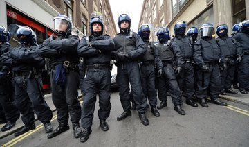 Riot police stand guard near a building thought to be an anti-capitalist squat in central London. (AFP file photo)