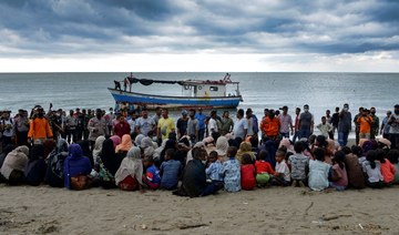 Evacuated Rohingya from Myanmar sit on the shorelines of Lancok village, in Indonesia's North Aceh Regency, after some 100 peopl