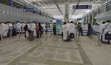 Pilgrims go through passport control upon their arrival at King Abdulaziz International Airport in Jeddah. (File/AFP)