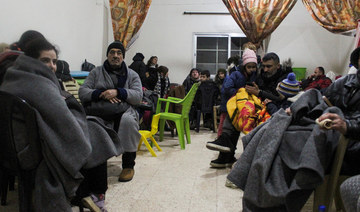People sit together at a temporary shelter in the aftermath of the earthquake in Aleppo, Syria February 6, 2023. (Reuters)