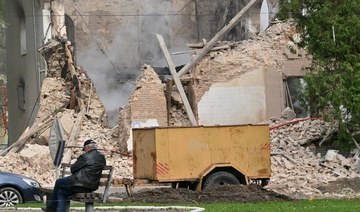 A man sits outside a building destroyed by Russian, Iranian-made, drones after an airstrike on Bila Tserkva, southwest of Kyiv.
