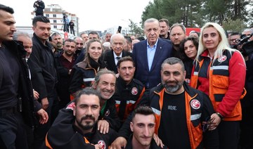 Erdogan poses with rescue team members at Turkey's Disaster and Emergency Management Presidency coordination centre, Adiyaman.