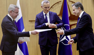 Finnish Foreign Minister Pekka Haavisto, left, hands his nation's accession document to US Secretary of State Antony Blinken