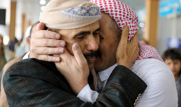 A freed detainee, released unilaterally by Saudi Arabia, embraces a relative at Sanaa Airport.