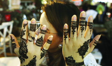 A girl shows her henna design in the Gulf Market ahead of the Eid Al-Fitr festival in Karachi. (AN photo)
