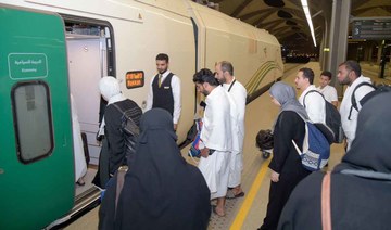 Muslim pilgrims are seen boarding a train at Makkah's train station. (AFP)