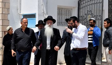 Members of the Jewish community leave a yeshiva in the Hara Kebira, the main Jewish quarter of Djerba.