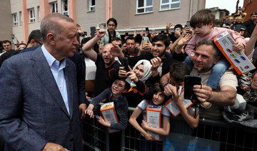 Turkish President Tayyip Erdogan greets his supporters after he casts his ballot at a polling station in Istanbul, Turkey.
