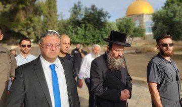 Israel’s National Security Minister Itamar Ben-Gvir (L) walks through the courtyard of Jerusalem’s Al-Aqsa mosque complex.