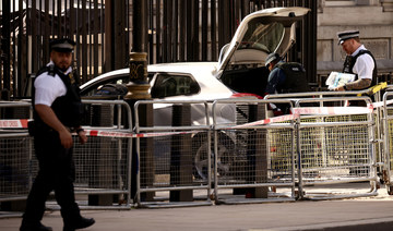 Police officers work at the site where a car crashed into the front gates of Downing Street in London, Britain, May 25, 2023.