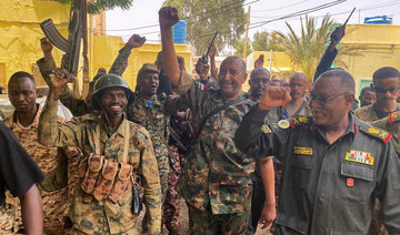 Army chief Abdel Fattah Al-Burhan cheers with soldiers as he visits some of their positions in Khartoum. (AFP)