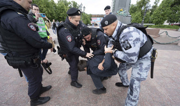 Police officers detain a demonstrator in Pushkinskaya Square in Moscow, Russia, Sunday, June 4, 2023. (AP)
