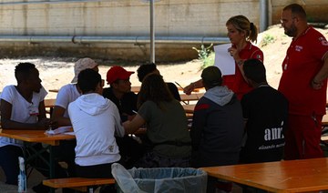 On Lampedusa, Red Cross takes over grim migrant hub