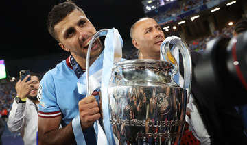 Manchester City’s Rodri bites the trophy as he celebrates winning the Champions League. (Reuters) 