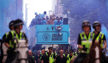 Man City celebrate winning treble of major trophies with open-top bus parade in rain