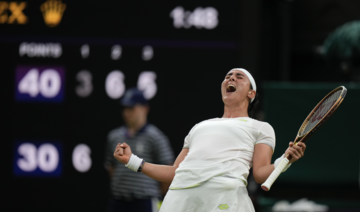 Tunisia’s Ons Jabeur celebrates after beating Canada’s Bianca Andreescu in a women’s singles match on day six of Wimbledon. (AP)