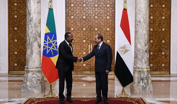 Egyptian President Abdel Fattah El-Sisi shakes hands with Ethiopian Prime Minister Abiy Ahmed after their meeting.