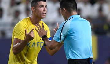 Al-Nassr's Cristiano Ronaldo argues with the referee during the AFC Champions League playoff match against Shabab Al-Ahli. AFP