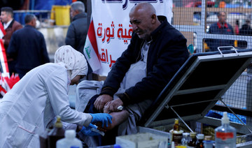 An Iraqi nurse helps a man in Baghdad, Iraq January 12, 2020. (REUTERS)