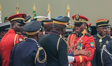 Gabon’s new strongman General Brice Oligui Nguema (2nd R) greets members of staff after he was inaugurated as interim president.