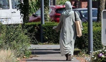 A woman wearing an abaya walks through the streets of Lille, northern France. (File/AFP)