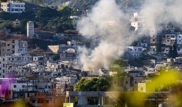 Smoke billows after a projectile lands near a centre of the Palestinian Fatah movement in the Ain Al-Helweh camp. 