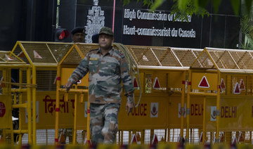 An Indian paramilitary soldier stands guard next to a police barricade outside the Canadian High Commission in New Delhi, India.