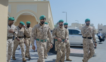 Bahraini military personnel are pictured after performing funeral prayers for their colleagues who were killed on Monday. (BNA)