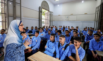 An Egyptian teacher instructs students on the first day of the academic year at Al-Sadeeya school, in Cairo, Egypt October 1.