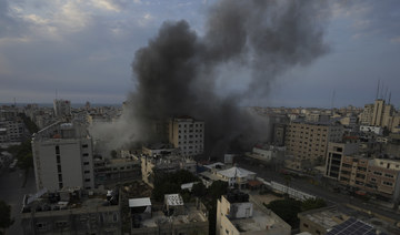 Smoke rises from an explosion on the Islamic National Bank following an Israeli air strike in Gaza City, Sunday, Oct. 8, 2023. 