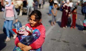 A girl carries a bag, as Palestinians fleeing north Gaza head towards the south on November 9, 2023. (Reuters)
